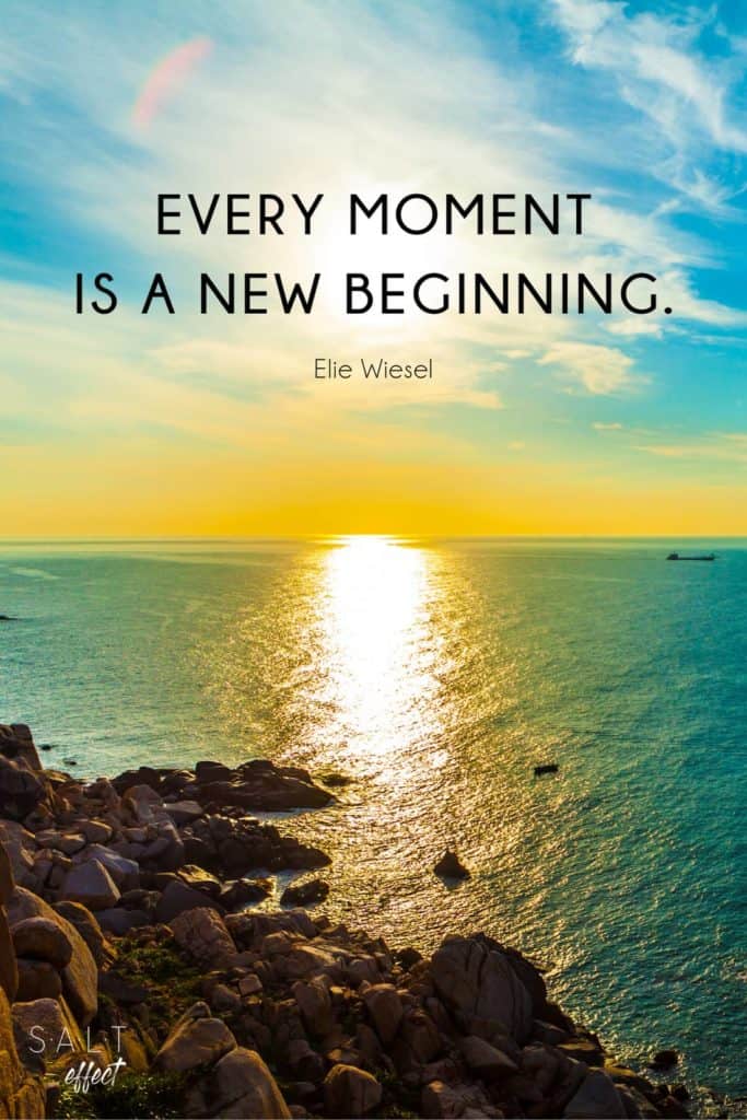 A new beginnings quotes pin: "Every moment is a new beginning." Quote by Elie Wiesel in black text. Background is a sunrise over the ocean with rocks in the foreground.