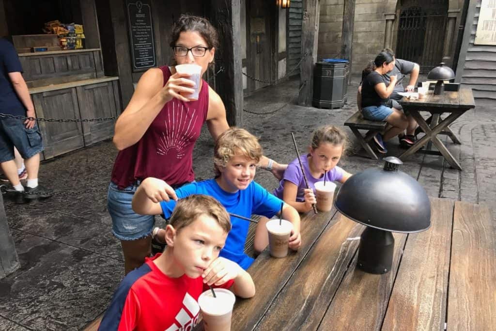 three kids and mom drinking butterbeer at the Wizarding World of Harry Potter