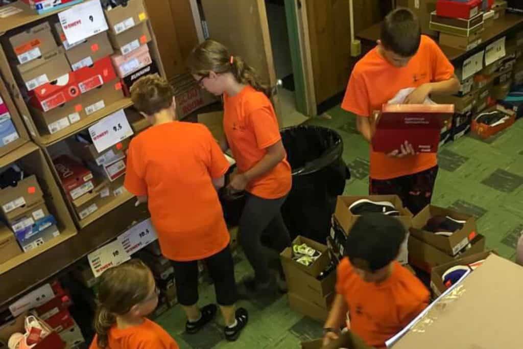 Give kids and one adult sorting and labeling shoe boxes at a shoe closet.