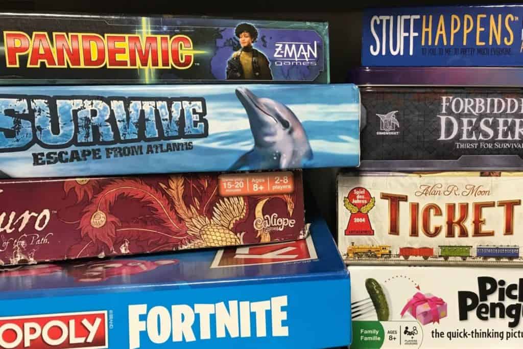 stack of some of the best board games for teenagers and tweens