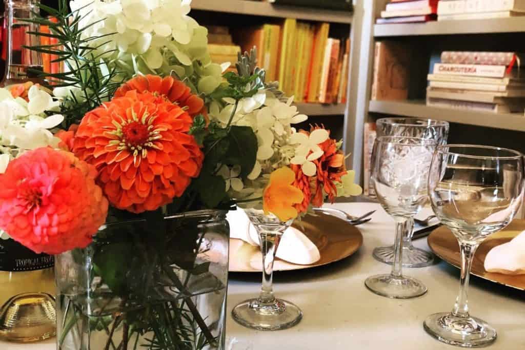 Beautifully set table with fresh-cut flowers at The Seasoned Farmhouse restaurant