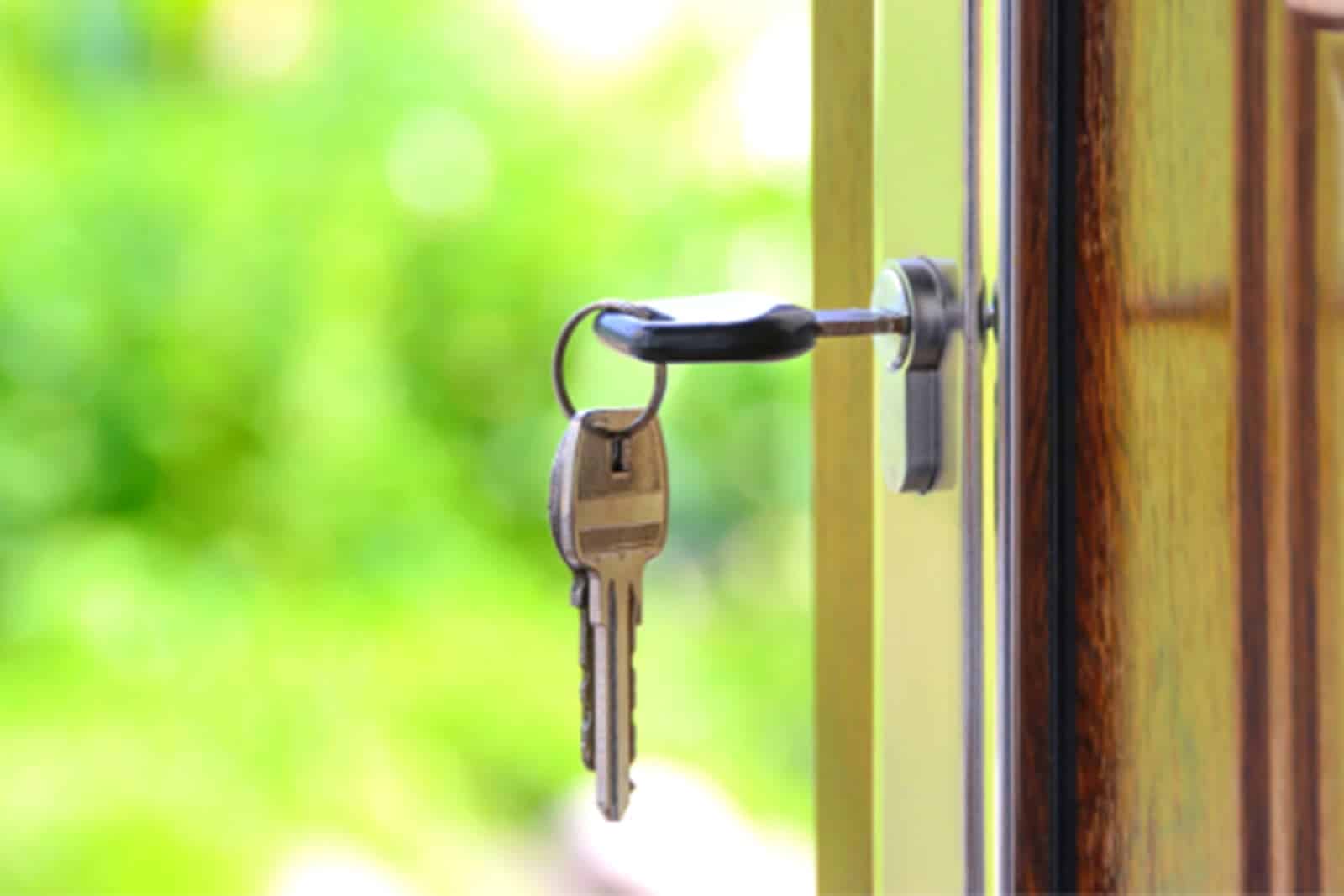 key hanging from the lock in a front door