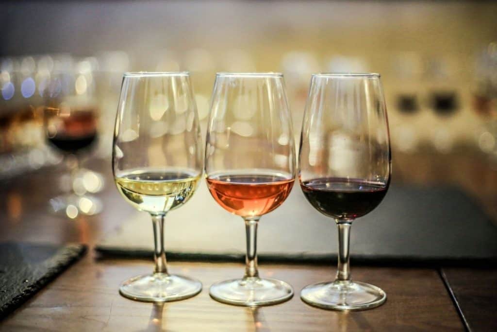 three wine glasses at a wine tasting