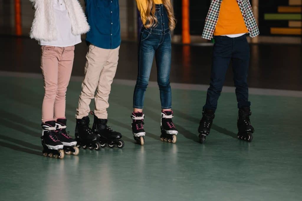 kids wearing roller skates at a roller rink