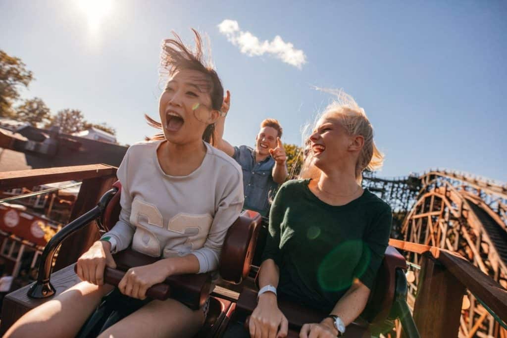 teens screaming on a roller coaster