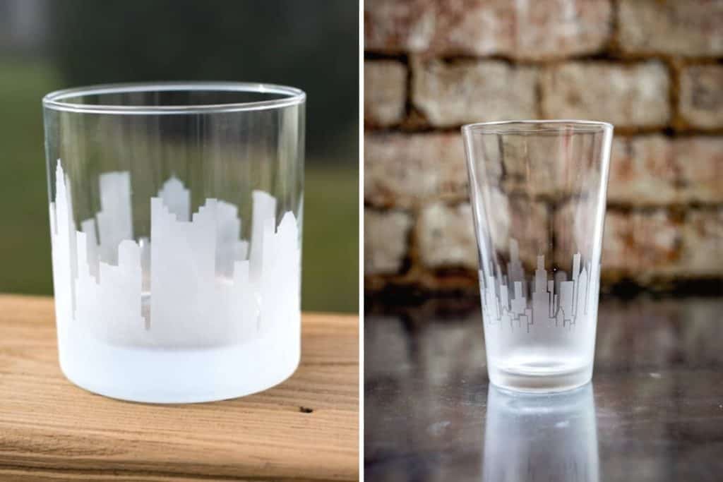 Columbus skyline etched on a rocks glass and Chicago skyline etched on a pint glass