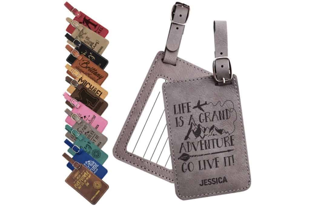 Leather luggage tags in 11 colors. Gray tag is shown as a sample with quote "life is a grand adventure, go live it" and a name engraved.