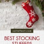 Pinterest pin that says "Best stocking stuffers for college students" on the backdrop of a red stocking against a white brick background