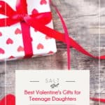 Best Valentine's Gifts for Teenage Daughters pin. Image of gift wrapped with white paper with red hearts and a long red bow