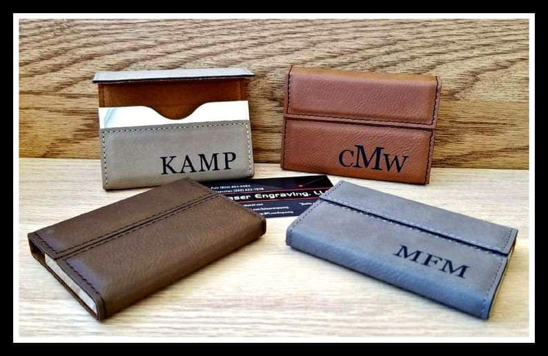 Business card holders for college graduation gifts. Four leather card holders in brown, gray, reddish brown and blue. Stamped with initials or name.