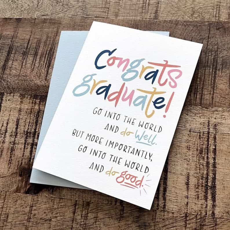 Card for college graduation gifts for guys. White card with light blue envelope. Card says: Congrats graduate! Go into the world and do well. But more importantly, go into the world and do good.