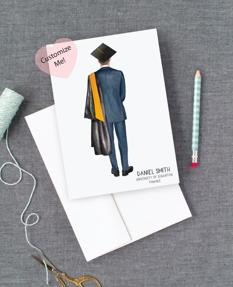 Customizable card as college graduation gifts for guys. Image of back of a male graduate, dressed in blue suit with black graduation robe and yellow sash over shoulder and black graduation cap. Name, university and major are in the bottom right corner.