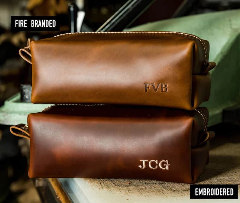 2 brown leather dopp kits with monogrammed initials as college graduation gifts for guys