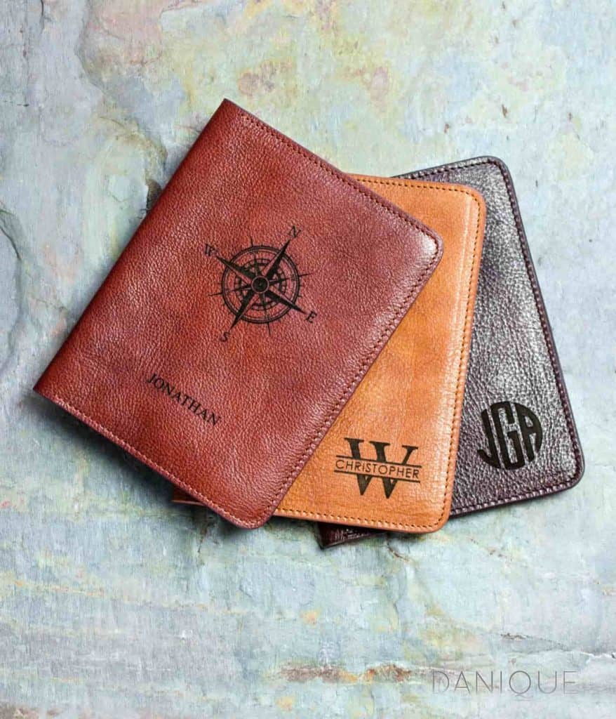 3 leather passport covers as college graduation gifts for guys. Colors are cinnamon, honey and espresso. Covers are engraved with a compass and first name, last initial and first name, and monogram.