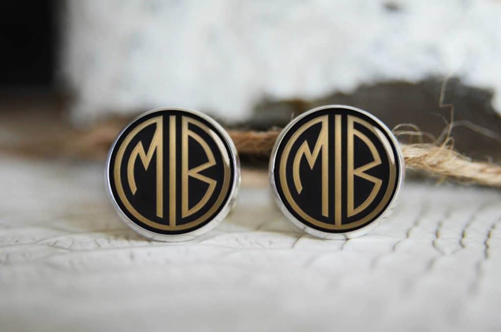 Round vintage style monogrammed cufflinks for college graduation gift. Silver border, black background, matte gold letters MB.