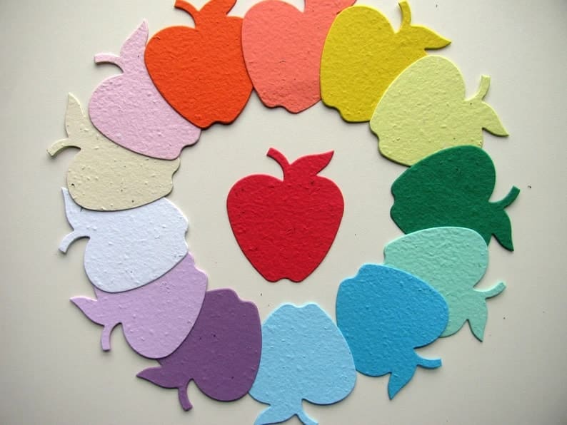 seed paper in the shape of apples arranged in a circle to showcase different colors. Red apple seed paper for teachers in the center