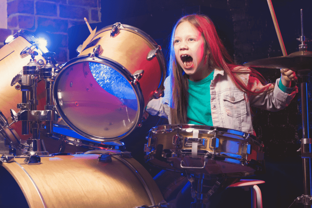 young girl playing drums
